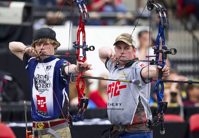 Sebastian Cooper, left, and Kyle Douglas compete in a shootout for the Young Adult division during "The Vegas Shoot" archery tournament at the South Point Sunday, Feb. 8, 2015. Douglas finished in first place and won a $3,500 cash prize.