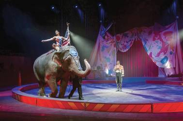 In this photo from Thursday, Feb. 19, 2015, ringmaster Andre McClain, center, holds his hat to his heart as the national anthem is played during the opening of the Ringling Brothers and Barnum & Bailey Circus "Built to Amaze" show at Knoxville Civic Coliseum in Knoxville, Tenn.