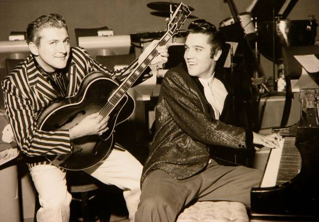 Liberace and Elvis Presley trade jackets and instruments in an impromptu jam session Nov. 14, 1956, at the Riviera.