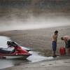 Photo: People prepare to launch watercraft as wind kicks Photo: People prepare to launch watercraft as wind kicks