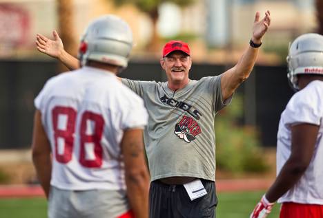 UNLV offensive coordinator Barney Cotton smiles at his players early in their first football team practice of the regular season on Friday, August 7, 2015.