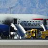 Photo: Firefighters stand by a British Airways plane that Photo: Firefighters stand by a British Airways plane that