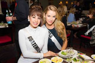 2015 Miss Guatemala Jeimmy Tahiz Aburto and 2015 Miss USA Olivia Jordan of Oklahoma attend the welcome dinner at Buca di Beppo on Monday, Dec. 7, 2015, at Bally’s.
