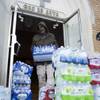 Photo: Maurice Rice organizes cases of water at Joy Taber Photo: Maurice Rice organizes cases of water at Joy Taber