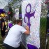 A woman writes on a memorial sheet adorned with the symbol Prince once used to identify himself outside Paisley Park on Saturday, April 23, 2016, in Chanhassen, Minn. A woman writes on a memorial sheet adorned with the symbol Prince once used to identify himself outside Paisley Park on Saturday, April 23, 2016, in Chanhassen, Minn.