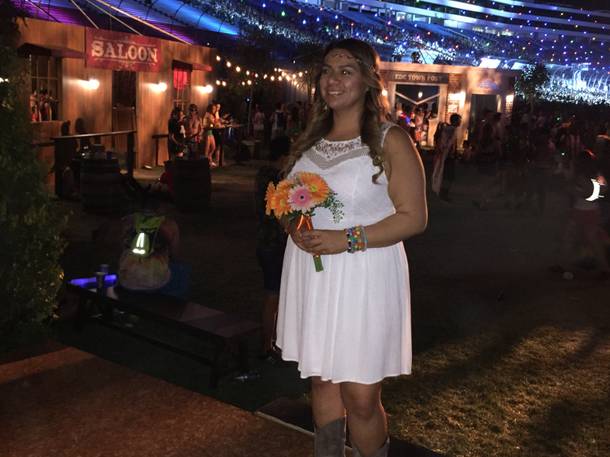 Maria Sisneros of San Jose, Calif., prepares to wed Evangelina Alcantar, her girlfriend of 10 years, at the “Chapel of Nature” during Night 3 of the Electric Daisy Carnival early Monday, June 20, 2016, at Las Vegas Motor Speedway.