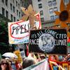 Photo: Climate change activists carry signs as they march Photo: Climate change activists carry signs as they march