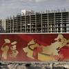 In this Friday, Aug. 26, 2016, photo, a wall with symbols of China partially blocks the view of the Resorts World property in Las Vegas. The Asian-themed casino property is projected to open in 2019. In this Friday, Aug. 26, 2016, photo, a wall with symbols of China partially blocks the view of the Resorts World property in Las Vegas. The Asian-themed casino property is projected to open in 2019.