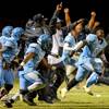 Photo: Canyon Springs coaches and players erupt from the Photo: Canyon Springs coaches and players erupt from the