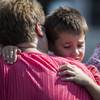 Photo: A woman hugs a boy following a shooting at Townvil Photo: A woman hugs a boy following a shooting at Townvil