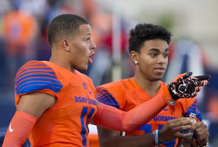 Bishop Gorman's Damuzhea Bolden (11) comments to a teammate while watching St. Thomas Aquinas of Florida warm up before their game as they try to remain undefeated, Friday, Sept. 30, 2016.