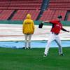 Boston Red Sox pitcher Drew Pomeranz, right, tosses a baseball in the outfield in front of grounds crew workers Sunday, Oct. 9, 2016, at Fenway Park in Boston. Rain postponed Sunday's scheduled Game 3 of baseball's American League Division Series between the Cleveland Indians and the Red Sox until Monday. Boston Red Sox pitcher Drew Pomeranz, right, tosses a baseball in the outfield in front of grounds crew workers Sunday, Oct. 9, 2016, at Fenway Park in Boston. Rain postponed Sunday's scheduled Game 3 of baseball's American League Division Series between the Cleveland Indians and the Red Sox until Monday.