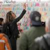 Photo: A commuter places a Post-it note on the Photo: A commuter places a Post-it note on the