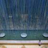 Photo: A girl sits near an art installation titled Photo: A girl sits near an art installation titled