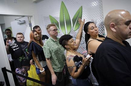 People wait in line at the Essence cannabis dispensary in Las Vegas, Saturday, July 1, 2017, as recreational sales of marijuana begin.