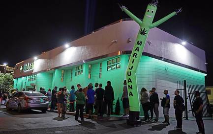 In this Saturday, July 1, 2017, file photo, people line up at the NuLeaf marijuana dispensary in Las Vegas.