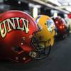 Photo: UNLV and other helmets are lined up on display dur Photo: UNLV and other helmets are lined up on display dur