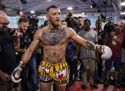 Conor McGregor breaks into a dance during a media workout before a large crowd within the gym at the UFC Performance Institute on Friday, August 11, 2017.