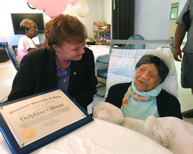In this photo provided by Pennsylvania's Department of Aging, Delphine Gibson, right, is visited by Aging Secretary Teresa Osborne, at AristaCare Thursday, Aug. 17, 2017, in Huntingdon Park, Pa. Gibson, the oldest known living person in the United States celebrated her 114th birthday on Thursday in Pennsylvania.