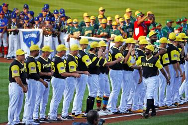 Pittsburgh Pirates' Andrew McCutchen, lower right, is introduced as Little League World Series teams, rear, from around the world line the infield before the Little League Classic baseball game between the Pirates and the St. Louis Cardinals at Bowman Field in Williamsport, Pa., Sunday, Aug. 20, 2017.