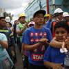Photo: Onlookers applaud as people raise a Mexican flag m Photo: Onlookers applaud as people raise a Mexican flag m