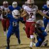 Photo: Liberty's QB Kenyon Oblad (7) fights to break a ta Photo: Liberty's QB Kenyon Oblad (7) fights to break a ta