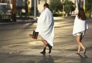 People walk near the Las Vegas Strip shortly after sunrise Monday, Oct. 2, 2017, in Las Vegas. A deadly shooting occurred Sunday at a music festival on the Las Vegas Strip.