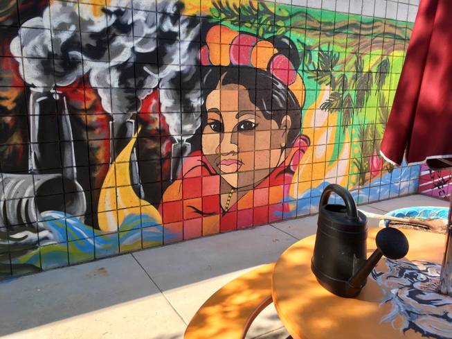 Painted by one of the Quannah McCall Elementary School garden's main caretakers, 5th-grade classroom aide Elena Fernandez, this mural seems to hint at a journey from urban decay to green bounty. Right next to it, she has been working on a compost pile in an old kiddie pool using cafeteria waste.