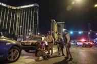 Police officers are shown at the scene of a shooting near Mandalay Bay on the Las Vegas Strip, Sunday, Oct. 1, 2017. Hundreds of victims were transported to hospitals after a shooting late Sunday at a music festival on the Strip.