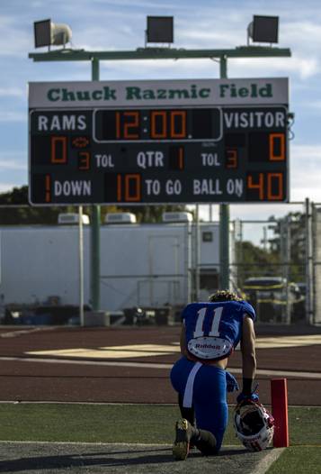 Liberty's Jake Dedeaux (11) takes a moment for reflection as they face Bishop Gorman during their state semifinal football game at Rancho High School on Friday, Nov 24, 2017. The turf field at Rancho will be replaced during the 2019-20 school year, forcing the Rams to play all of their games on the road.