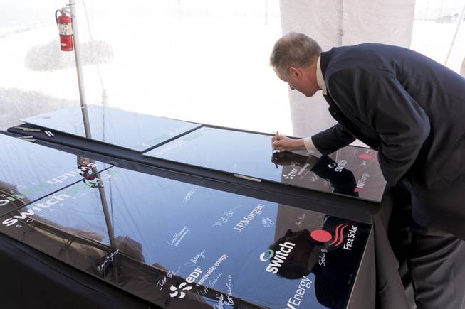 Nev. assemblyman Keith Pickard signs the commemorable solar panels during a ceremony to celebrate the commissioning of the 179 megawatt Switch Station 1 and 2 Solar Projects, Monday, Dec. 11, 2017. This is the first-ever project to be built in one of the Bureau of Land Management's Solar Energy Zones.