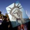 Photo: Esperansa Solorio holds a Statue of Liberty-themed Photo: Esperansa Solorio holds a Statue of Liberty-themed