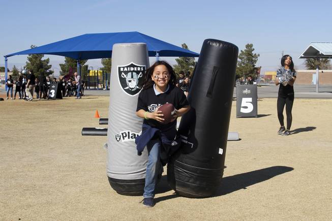 The Raiders, including Raider alumni Reggie Kinlaw and their mascot Raider Rusher, and the Nevada Dairy Council gave Sandy Searles Miller Academy a $10,000 Hometown Grant award in conjunction with the Fuel up to Play 60 campaign, which encourages kids to be active an hour a day, Wednesday, February 28, 2018. MICK ACKERS