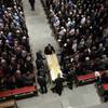 Photo: Grandson pallbearers prepare the casket of former Photo: Grandson pallbearers prepare the casket of former