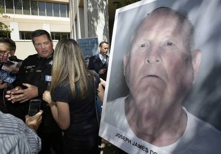 Sacramento County Sheriff Scott Jones, left, talks to reporters about the arrest Joseph James DeAngelo, seen in photo, on suspicion of committing a string of violent crimes in the 1970's and 1980's after a news conference on Wednesday, April 25, 2018, in Sacramento, Calif. A DNA match led to the arrest of DeAngelo, 72, Tuesday. DeAngelo is believed to have committed at least 12 slayings and 45 rapes in California.