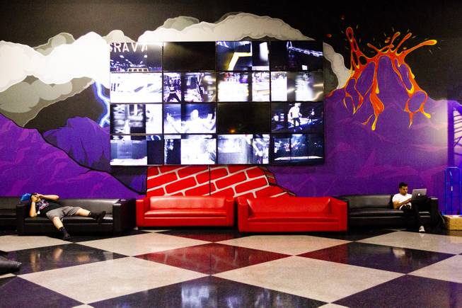 Two people play with their electronic devices in the lobby of Gravady during the second annual FlipCon event sponsored by Circus Trix in Las Vegas, Monday, 23, 2018. FlipCon invites influencers from all over the U.S. to participate in SuperTramp activities to produce content for their fan base and to network with fellow influencers.