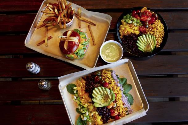 The Southwest Avocado Monsoon salad (front) and Cha Cha Burger with Rosemary Fries (back) from Blinders Burgers & Brunch