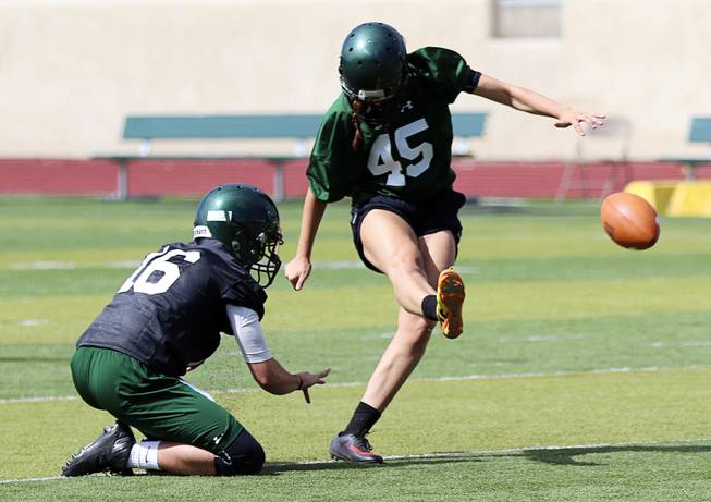 This undated photo provided by Adams State University shows place kicker Rebecca Longo (45) practicing in Alamosa, Colo. The field goal kicker from Adams State thought about her upper-most range for a moment. On the field, at least 54 yards, which is how far she connected on one during practice. In the arena of opening doors for other female football players, she hopes it’s endless. Rebecca "Becca" Longo became one of the first females to receive a football scholarship a season ago.