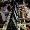 In this July 14, 2018, file photo, people, left, talk to tellers while placing bets at the Meadowlands Racetrack, in East Rutherford, N.J. In this July 14, 2018, file photo, people, left, talk to tellers while placing bets at the Meadowlands Racetrack, in East Rutherford, N.J.