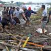 Photo: Residents carry a body bag containing the body of Photo: Residents carry a body bag containing the body of