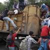 Photo: Honduran migrants bound to the U.S border climb in Photo: Honduran migrants bound to the U.S border climb in