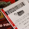 Photo: A Mega Millions lottery ticket rests on the shop c Photo: A Mega Millions lottery ticket rests on the shop c