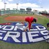 Photo: Grounds crew members paint the World Series logo b Photo: Grounds crew members paint the World Series logo b