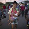 Photo: Maria Gomez, 22, carries her son David Moises, 1, Photo: Maria Gomez, 22, carries her son David Moises, 1,