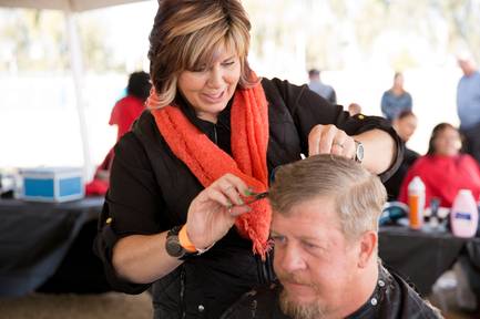 Donna Jordan, a hairstylist who volunteers at the Project Homeless Connect, gives a haircut to Army veteran Ronald Cochran, Tuesday, Nov. 20, 2018.