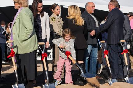 Nicole Beck looks on as her daughter Katriann Beck, 5, shovels dirt during the groundbreaking of the Alyn Beck Memorial Park, Tuesday, Dec. 18, 2018. Officer Beck was killed in the line of duty Sunday, June 8, 2014.