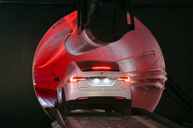 A modified Tesla Model X drives in the tunnel entrance before an unveiling event for the Boring Co. Hawthorne test tunnel in Hawthorne, Calif., Tuesday, Dec. 18, 2018. Elon Musk unveiled his underground transportation tunnel on Tuesday, allowing reporters and invited guests to take some of the first rides in the revolutionary albeit bumpy subterranean tube - the tech entrepreneur's answer to what he calls "soul-destroying traffic."