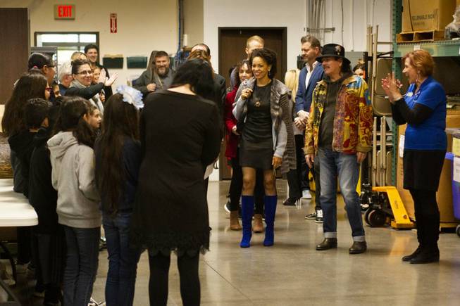 Students from CC Ronnow Elementary School and the staff from Spread the Word Nevada welcome Carlos Santana, his Milagro Foundation staff, and his wife Cindy Blackman as they arrive for a tour at the Spread the Word Nevada offices and warehouse in Henderson, NV, Thursday, Jan. 17, 2019. The Milagro Foundation made a donation to Spread the Word, which will provide about 15,000 books to 57 schools across Southern Nevada.