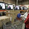 Photo: In this Feb. 22, 2009, file photo shoppers watch t Photo: In this Feb. 22, 2009, file photo shoppers watch t