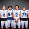 Photo: Members of the Basic High School football team are Photo: Members of the Basic High School football team are